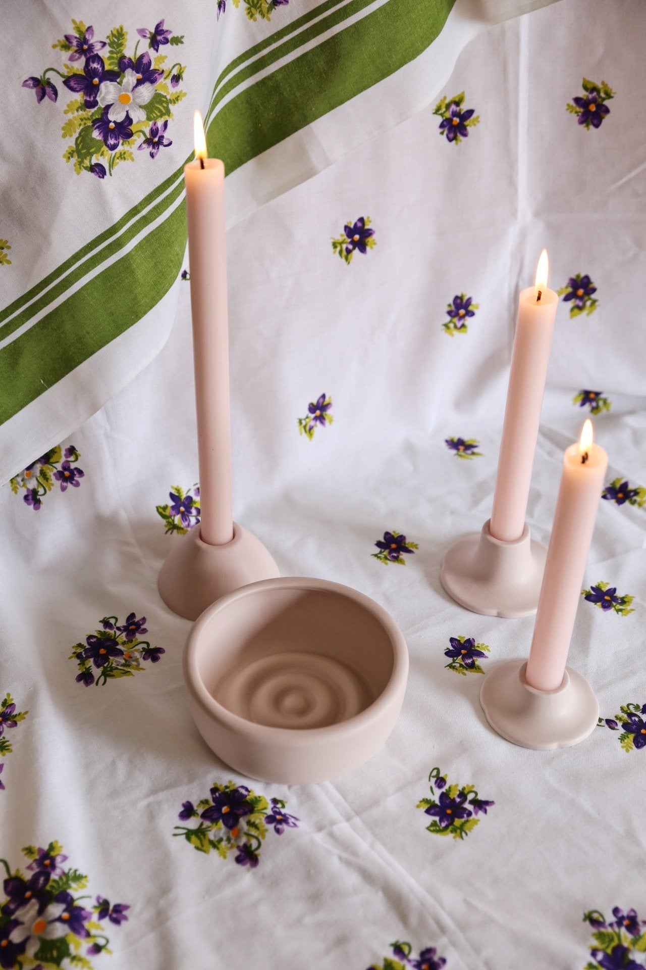 blush dinner candle holder with candles and round ceramic bowl
